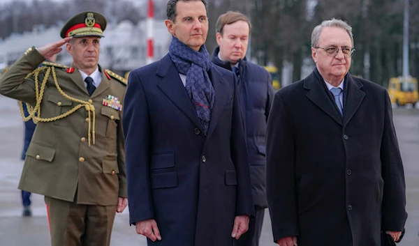 Syrian President Bashar Assad, left, and Mikhail Bogdanov, right, Deputy Minister of Foreign Affairs of Russia, review an honor guard during a welcome ceremony upon Assad's arrival at Vnukovo airport in Moscow, Russia, Tuesday, March 14, 2023 (SANA)