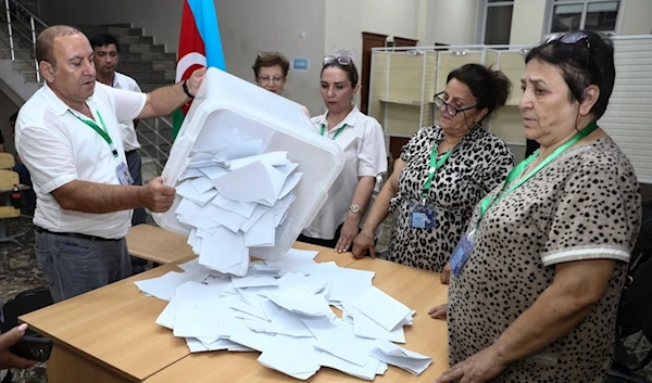 Members of an election commission prepare to count ballots at a polling station after a snap election in the Milli Mejlis parliament in Baku, Azerbaijan, Sunday, Sept. 1, 2024. (AP Photo)