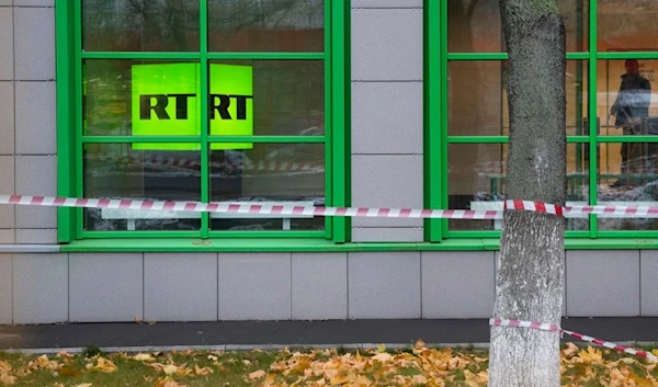 In this file photo taken dated Friday, Oct. 27, 2017, Russian state-owned television station RT logo is seen at the window of the company's office in Moscow, Russia. (AP)