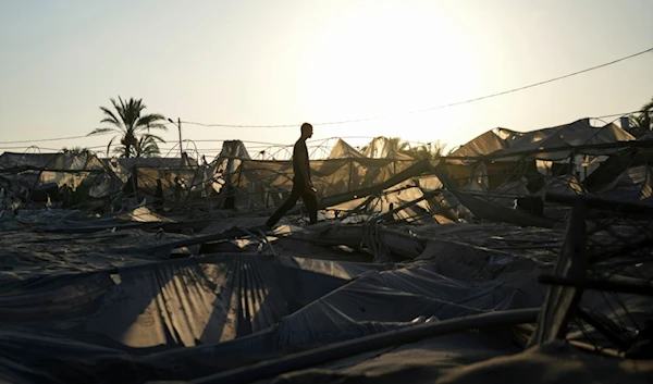 Palestinians look at the destruction after an Israeli airstrike on a crowded tent camp housing Palestinians displaced by the war in Muwasi, Gaza Strip, Tuesday, Sept. 10, 2024. (AP)