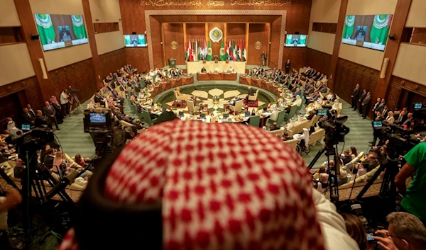 A photographer films the regular session of the Arab League, in Cairo, Egypt, Tuesday, September 10, 2024 (AP)