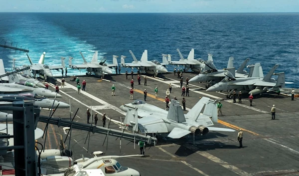 In this photograph released by the US Navy, the flight deck of the Nimitz-class aircraft carrier USS Theodore Roosevelt is seen July 4, 2024, in the South China Sea. (AP)