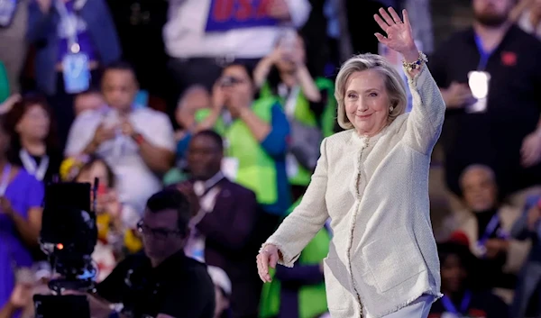 Hillary Clinton waves as she arrives on stage to speak on the first day of the Democratic National Convention at the United Center in Chicago, August 19, 2024. (AFP)