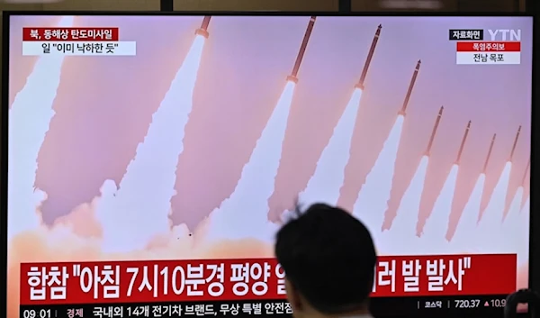 People watch a television screen showing a news broadcast with file footage of a North Korean missile test, at a train station in Seoul on September 12, 2024. (AFP)