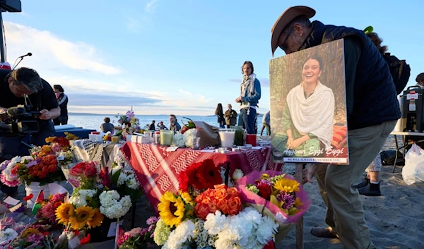 A photo is seen among flowers in memory of Aysenur Ezgi Eygi, 26, at a vigil on Alki beach in memory of Eygi, who was recently killed in the occupied West Bank, September 11, 2024. (AP)