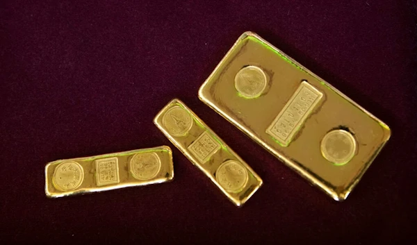 In this April 16, 2020, file photo, a customer puts gold bars on basket for sell to a gold shop in Bangkok, Thailand. (AP)