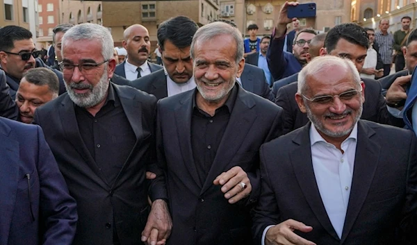 Iran's President Masoud Pezeshkian, center, visits the holy shrine of Imam Ali, in the southern Iraqi city of Najaf, September 12, 2024 (AP)