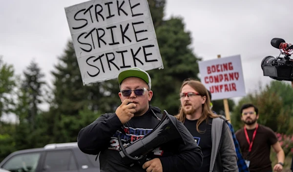 International Aerospace Machinists union members march toward the union's hall to vote on a contract offer with airplane maker Boeing, on Thursday, September 12, 2024, in Renton, Washington (AP)