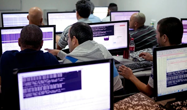 In this undated file photo, Israelis work on computers at the 'CyberGym' school in the coastal city of Hadera, occupied Palestine (AP)