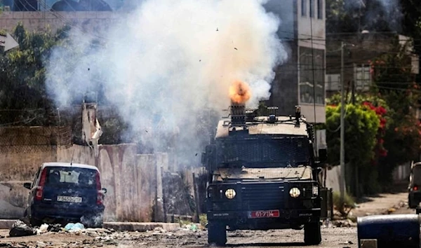 An Israeli armored vehicle fires tear gas during an incursion in Jenin city in the occupied West Bank on July 4, 2023. (AFP)