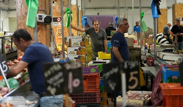 Vendors sell and vegetables in a market in Haifa, occupied Palestine, Monday, August 5, 2024. (AP)