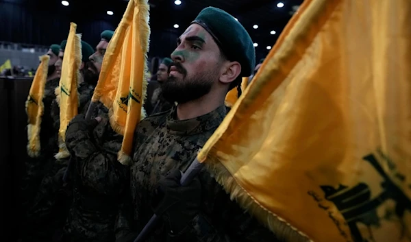 Hezbollah fighters march as they hold flags of Hezbollah during a rally to mark ]Al-Quds day, in a southern suburb of Beirut, Lebanon, Friday, April 5, 2024. (AP)