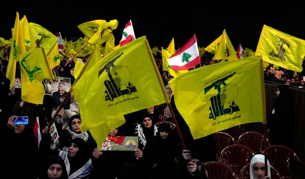 Hezbollah supporters wave Lebanese and Hezbollah flags during a ceremony to mark the third anniversary of the assassination of Iran's Quds force General Qassem Soleimani, Jan. 3, 2023. (AP)