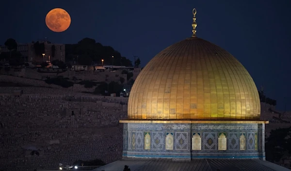 The super moon rises behind the Dome of the Rock shrine at the Al Aqsa Mosque compound in the Old City of al-Quds, Palestine, Aug. 19, 2024. (AP)