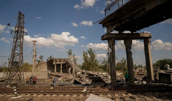 Railway workers look on the bridge destroyed by a Russian airstrike in Pokrovsk, Ukraine, Sept. 17, 2024. (AP)