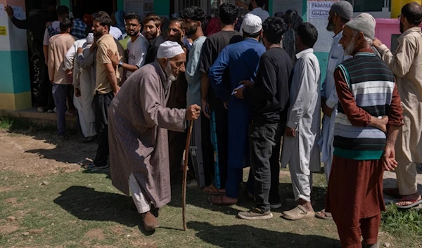 An elderly Kashmiri man walks back after casting his vote at a polling booth in in Bellow, south of Srinagar, Indian controlled Kashmir, Wednesday, Sept. 18, 2024. (AP)