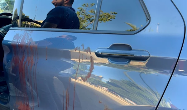 A police officer is reflected on the blood stained door of a car in which a hand-held pager exploded in Israeli terror attack, in Beirut, Lebanon, Tuesday, Sept. 17, 2024. (AP)