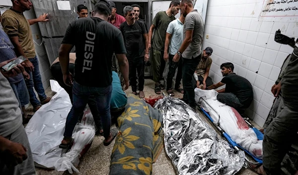 Palestinians check the bodies of their relatives killed in the Israeli bombardment of the Gaza Strip, at a hospital morgue in Deir al-Balah, Sunday, Sept. 1, 2024. (AP)