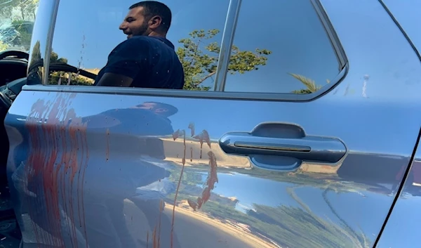 A police officer is reflected on the blood-stained door of a car in which a hand-held pager exploded in Israeli terror attack, in Beirut, Lebanon, Tuesday, Sept. 17, 2024. (AP)