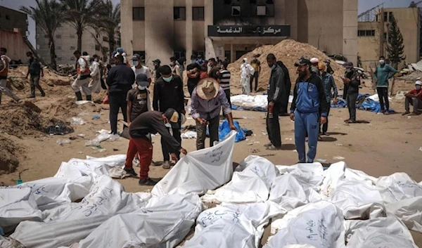 Palestinians search for their family members killed and buried in mass graves by IOF as health workers unearth the bodies in mass graves inside the Nasser hospital compound in Khan Younis in Gaza on April 21,2024. (AFP)