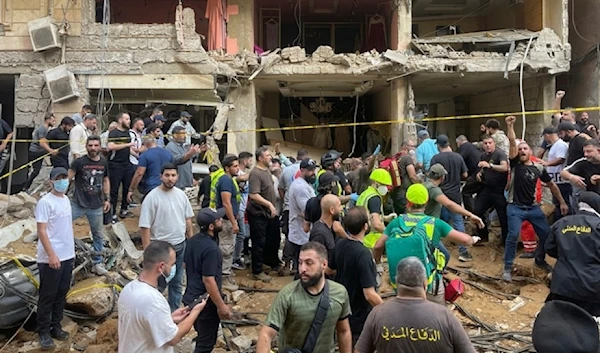 People gather near a damaged building at the scene of an Israeli missile strike in the southern suburb of Beirut Friday, September 20, 2024.  (AP)