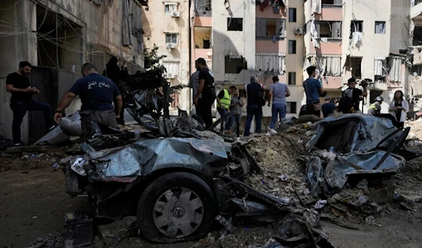 Emergency workers clear the rubble at the site of Friday's Israeli strike on Hezbollah leaders meeting in a basement in a building in Beirut's southern suburb, September 22, 2024. (AP)