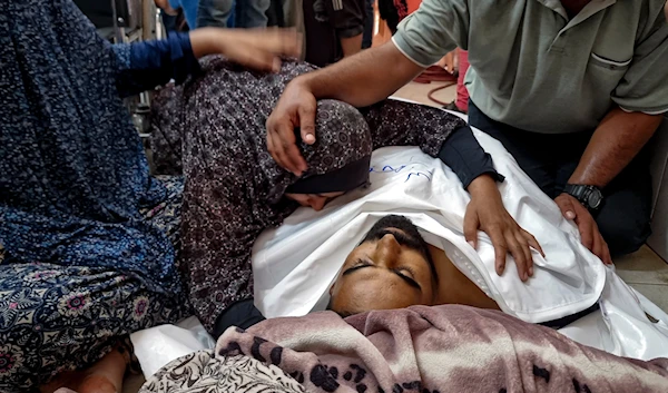 Palestinians mourn a relative killed in the Israeli bombardment of the Gaza Strip, at a hospital in Khan Younis, on August 24, 2024. (AP)