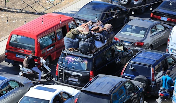 Cars sit in traffic in the southern city of Sidon, as they flee the southern villages amid ongoing Israeli airstrikes, Monday, Sept. 23, 2024. (AP Photo/Mohammed Zaatari)