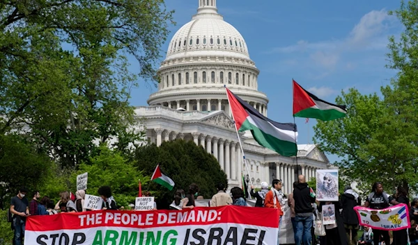 Pro-Palestinian activists demonstrate outside the Capitol in Washington, Saturday, April 20, 2024, as the House prepares to vote on approval of $95 billion in foreign aid for Ukraine, "Israel" and other US allies. (AP)