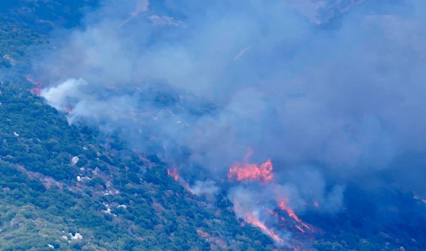 Smoke and flames rise from an Israeli airstrike on Mahmoudiyeh mountains, as seen from Marjayoun town, south Lebanon, on September 21, 2024. (AP)