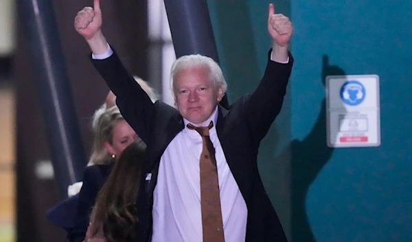 WikiLeaks founder Julian Assange gestures after landing at RAAF air base Fairbairn in Canberra, Australia, Wednesday, June 26 2024. (AP)