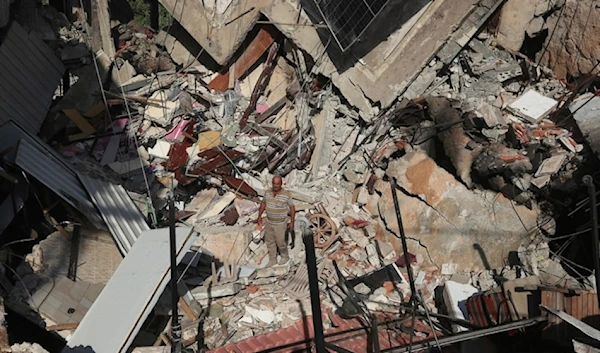 A man stands on the rubble of a building hit in an Israeli airstrike in the southern village of Akbieh, Lebanon, on Tuesday, September 24, 2024. (AP)