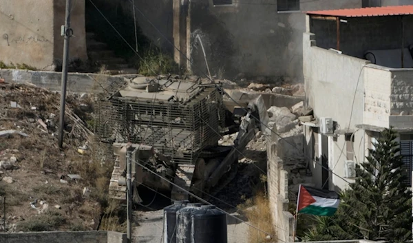 An Israeli army bulldozer moves through the West Bank town of Qabatiya during a raid, Thursday, Sept. 19, 2024. (AP Photo/Majdi Mohammed)