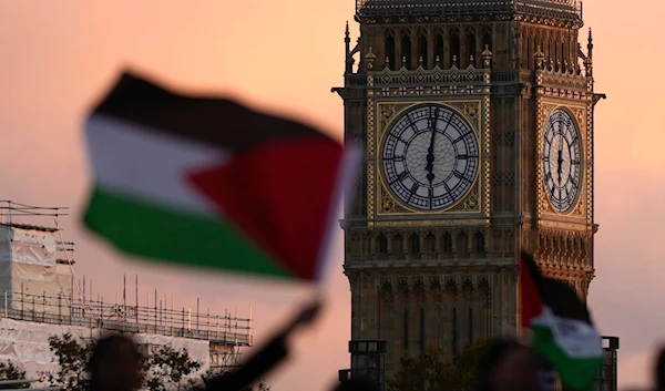 Protesters wave flags as they attend a pro Palestinian demonstration in London, Saturday, Oct. 14, 2023, (AP)