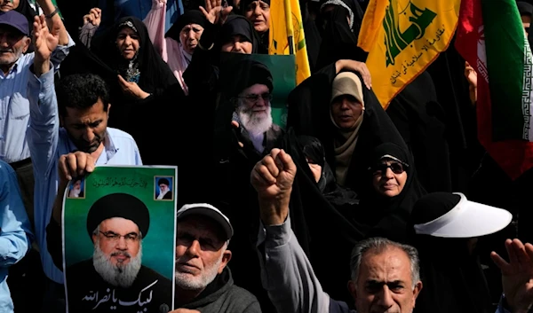 Iranians chant and hold posters of Supreme leader Ayatollah Ali Khamenei, center, and martyred Hezbollah Secretary-General Sayyed Hassan Nasrallah during an anti-Israeli rally after Friday prayers in Tehran, Iran, Friday, September 27, 2024 (AP)