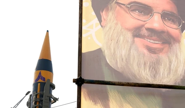 An Iranian domestically built missile is displayed in front of the portrait of the Lebanese Hezbollah leader Sayyed Hassan Nasrallah during a rally of Iran's Basij paramilitary force in support of Palestine in Iran, Nov. 24, 2023. (AP)