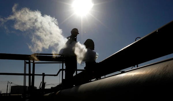 In this Feb. 26, 2011 file photo, a Libyan oil worker, works at a refinery inside the Brega oil complex, in Brega, eastern Libya. (AP)