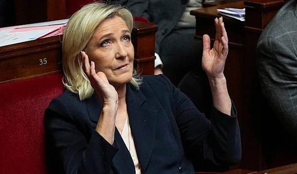 French far-right National Rally party leader Marine Le Pen reacts during the speech of French Prime Minister Gabriel Attal at the National Assembly, on January 30, 2024 in Paris. (AP)