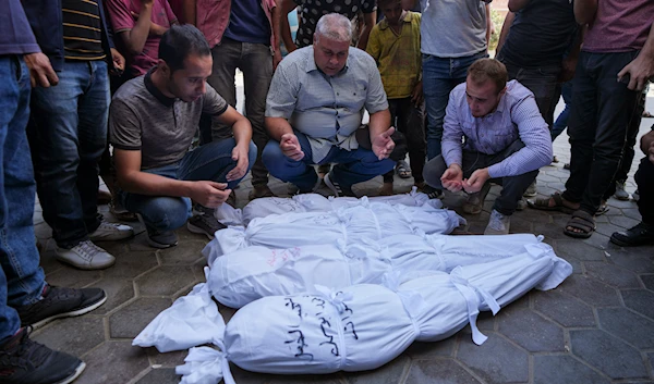 Palestinians mourn their relatives, including kids killed in the Israeli bombardment of the Gaza Strip, outside a morgue in Deir al-Balah, Gaza, September 23, 2024. (AP)