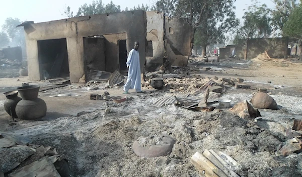 A man walks past burnt out houses following an attack by Boko Haram in Dalori village near Maiduguri, Nigeria, on January 31, 2016. (AP)