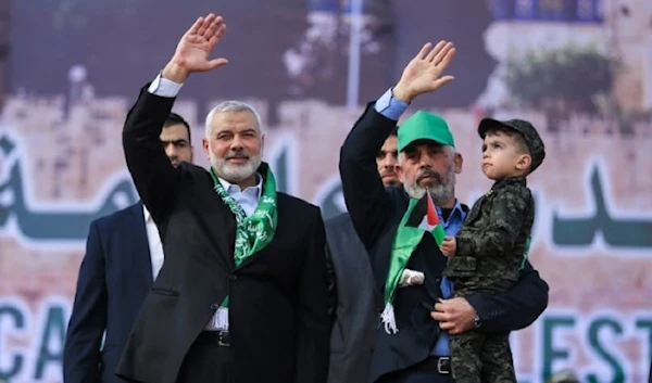 Martyr Ismail Haniyeh (L) and Hamas's leader in the Gaza Strip Yahya Sinwar wave during a rally marking the 30th anniversary of the founding of the resistance movement, in Gaza City, on December 14, 2017. (AFP)