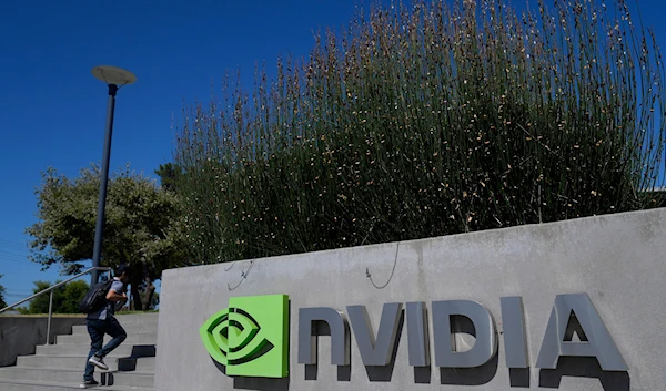 A person walks past a sign outside of a Nvidia office building in Santa Clara, Calif., on August 7, 2024. (AP)