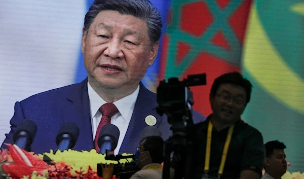 Cameramen film near a screen showing China's President Xi Jinping delivering an opening ceremony speech for the China Africa Forum, at the Great Hall of the People in Beijing, Thursday, September 5, 2024 (AP)