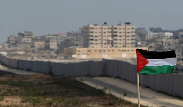 A Palestinian flag is seen against the wall of the Philadelphi corridor near Rafah, southern Gaza Strip, Palestine,  July 1, 2007. (AP)