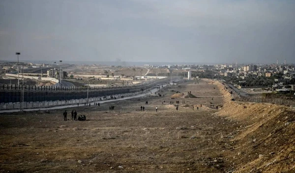 Palestinians are seen at the Egypt-Gaza border as they continue their daily lives under harsh conditions in Rafah, Gaza on January 18, 2024. (AP)