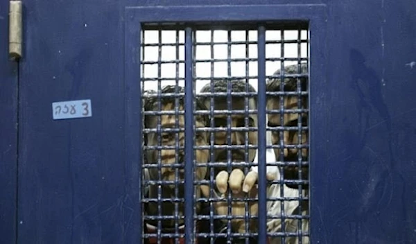 Palestinian detainees stand in a cell, pending their release from Ketziot prison in “Israel”, on October 1, 2007 (AP)