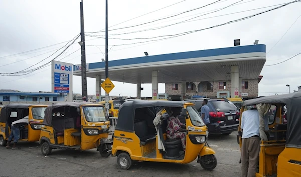 Tuktuk drivers queue to buy fuel at a petrol station in Lagos, Nigeria, Wednesday, July. 31, 2024 (AP)