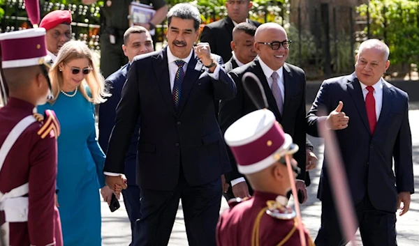 Venezuelan President Nicolas Maduro gestures to supporters as he walks hand-in-hand with his wife Cilia Flores upon arrival at the National Assembly for his swearing-in ceremony for a third term in Caracas, Venezuela, Friday, Jan. 10, 2025 (AP)