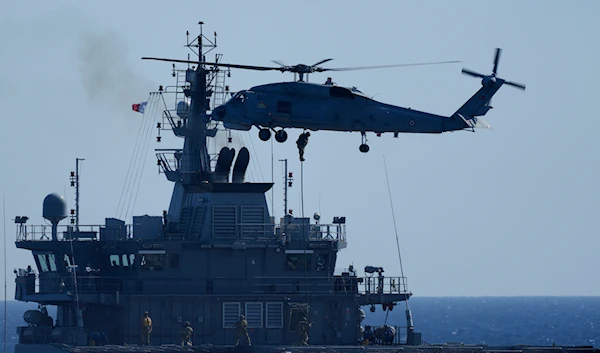 A military helicopter loads marines over a naval ship during an annual NATO naval exercise on Turkey's western coast on the Mediterranean, on September 15, 2022. (AP)