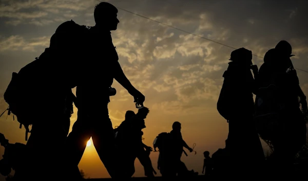 A silhouette of migrants walking at sunset, undated. (AFP)